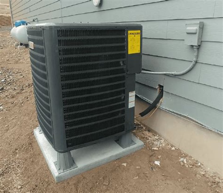 How high should a heat pump be off the ground?
